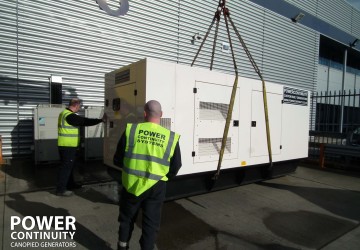 Power continuity 450kva generator lifted into place by engineers