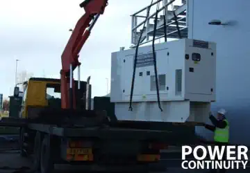 Power continuity canopied generator being delivered for installation