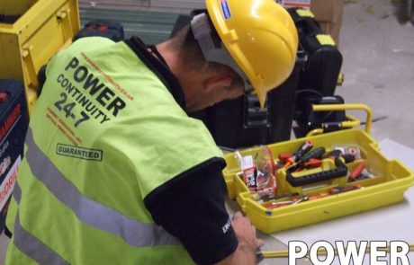Power continuity engineer carrying out maintenance work on a ups