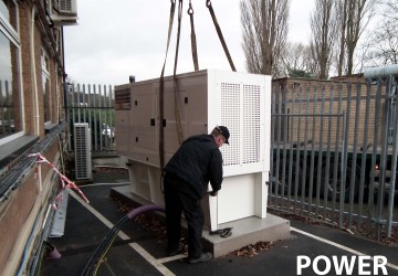 Power continuity engineer inspecting diesel generator