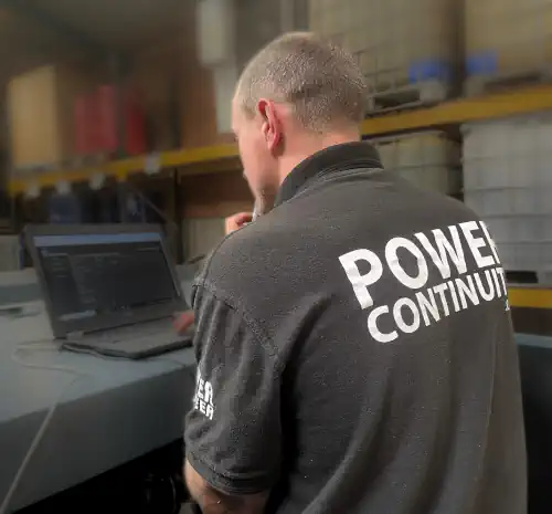 Power continuity engineer installing an emergency generator