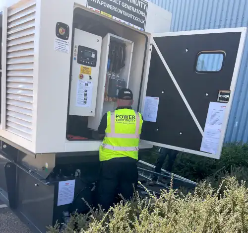 Power continuity engineer servicing a diesel powered generator