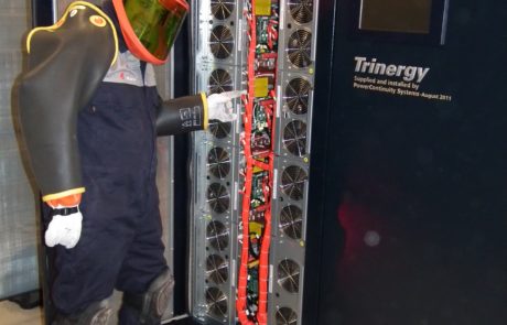 Power continuity engineer servicing a ups in an insulated rubber suit