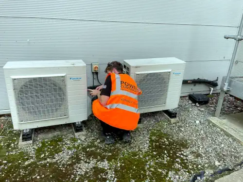 Power continuity engineer servicing air conditioning units