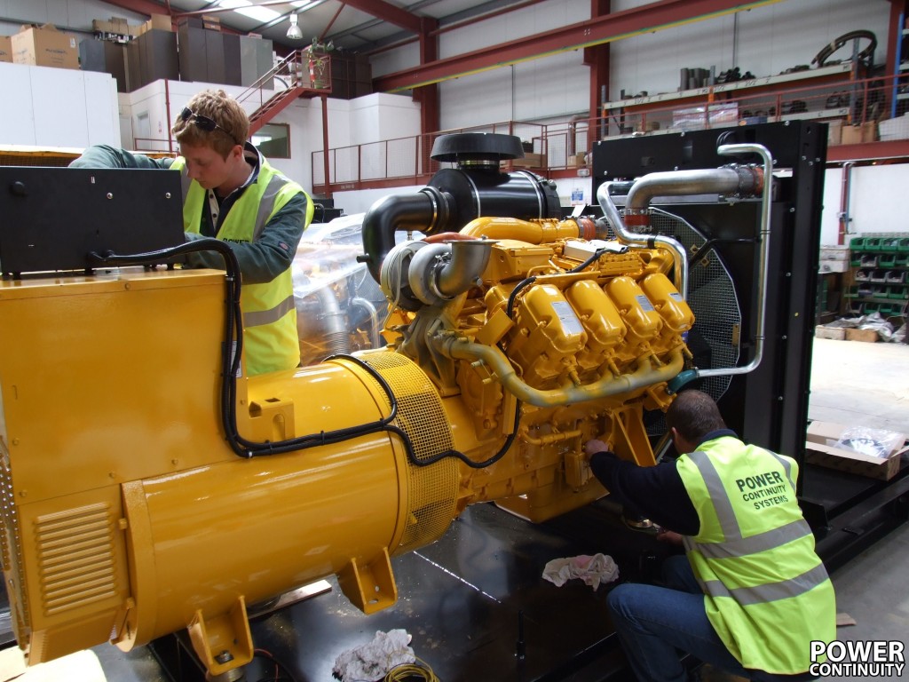Power continuity engineers checking oil level