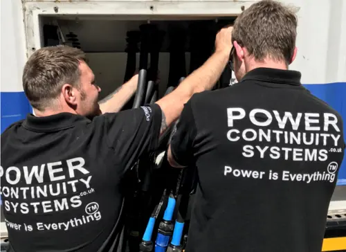 Power continuity engineers connecting a temporary ups system
