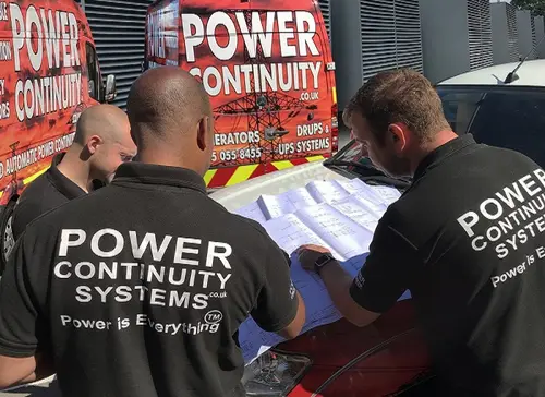 Power continuity engineers looking at schematics