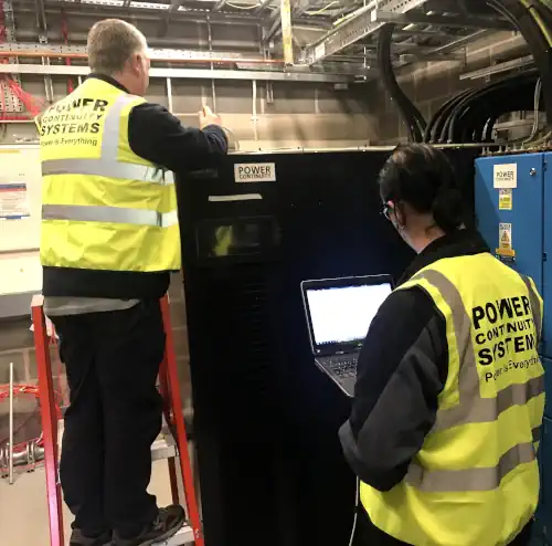 Power continuity engineers maintaining a ups