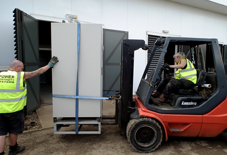 Power continuity engineers removing a ups