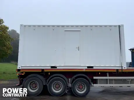 Power continuity ups container on low loader